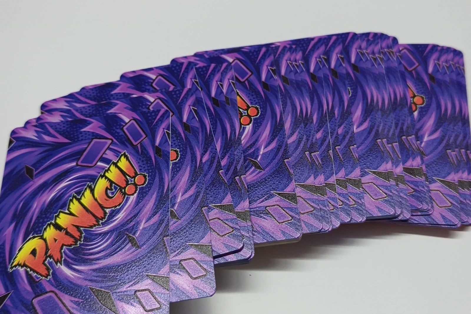 A finished custom card deck printed by Kulworks, fanned out to show the full-color card backs