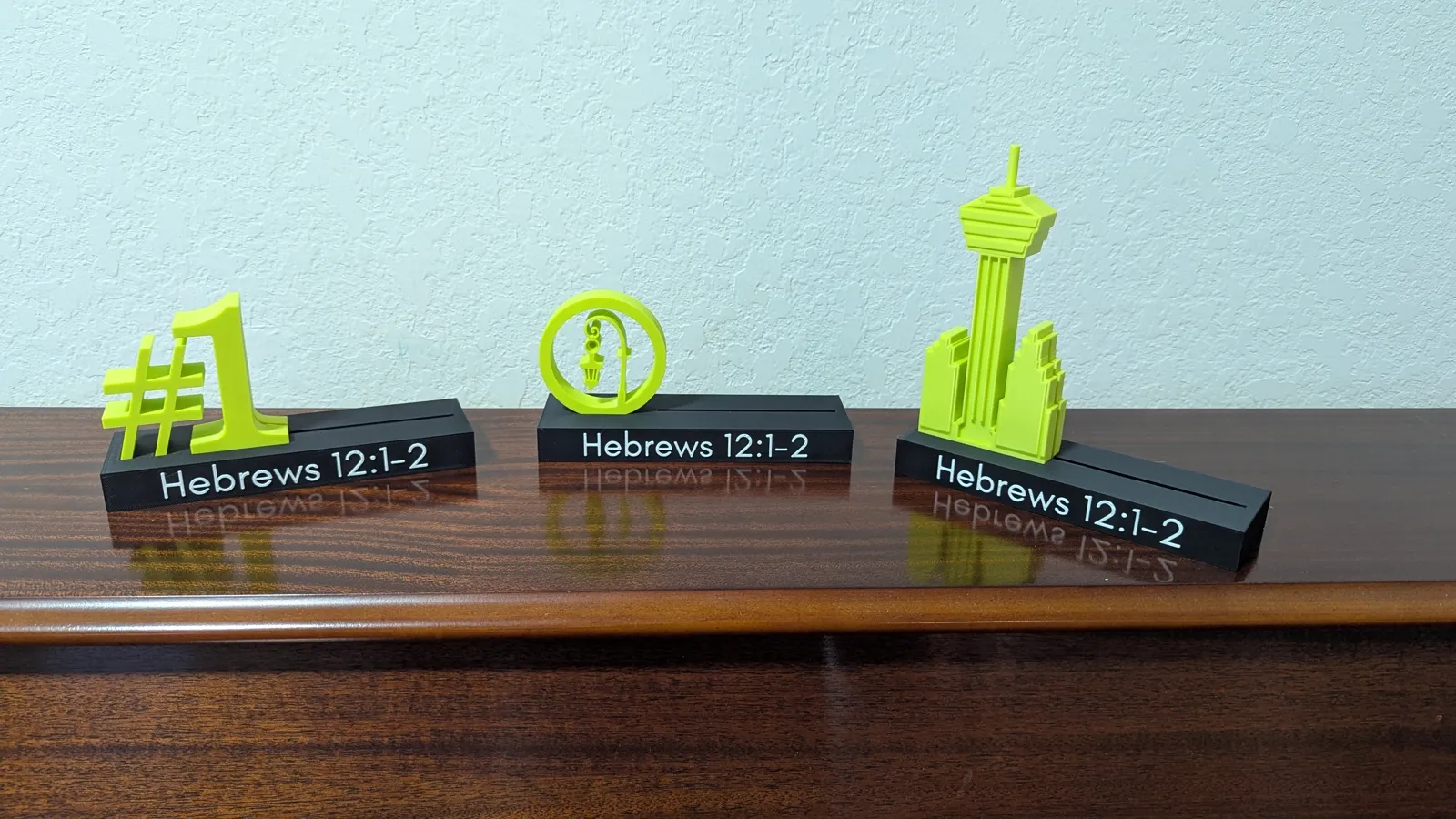 Custom 3D models designed in Shapr3D: award designs modeled from scratch, a fantasy football champion medallion shown as the model and as the finished two-colour print, client logos built as 3D artwork for Bulverde Astros and Bomber Bees, and character models.