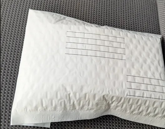 A white padded envelope, the standard way Kulworks card orders ship